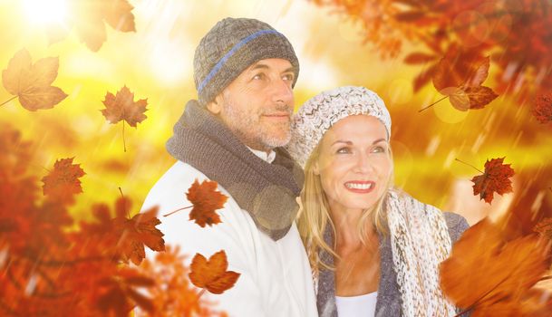 Composite image of cheerful couple in warm clothing