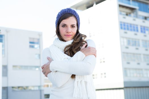 Brunette with warm clothes looking at camera 