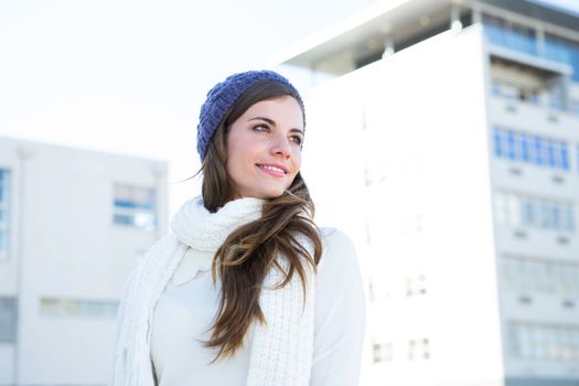 Brunette with warm clothes looking away 