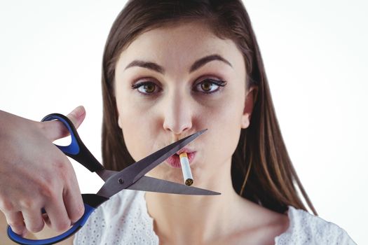 Woman cutting cigarette with scissors
