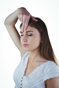 Woman meditating with hand on forehead