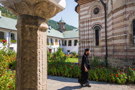 Priest walking inside Cozia monastery