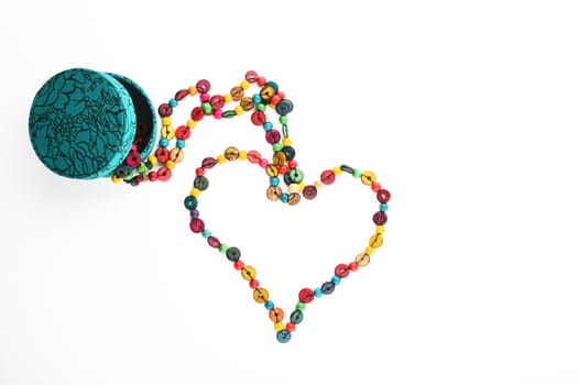 Heart shaped colorful beads isolated on white