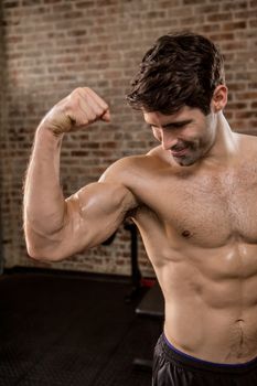 Shirtless man showing his biceps