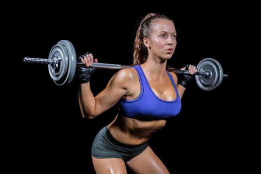 Sporty female bodybuilder lifting crossfit