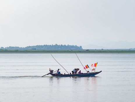 Boat with Buddhist flags in Myanmar