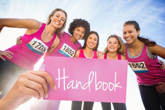 Handbook against five smiling runners supporting breast cancer marathon