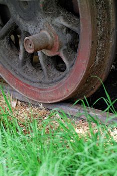 Photo of an old and rusty locomotive wheel