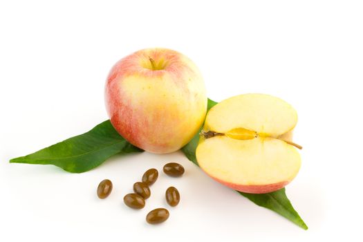 detail of pills and a apple with leaves