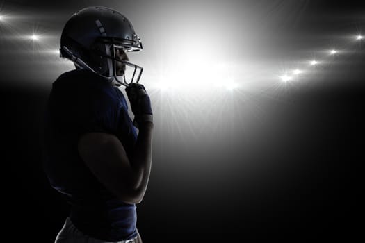 Composite image of side view of silhouette american football player wearing helmet