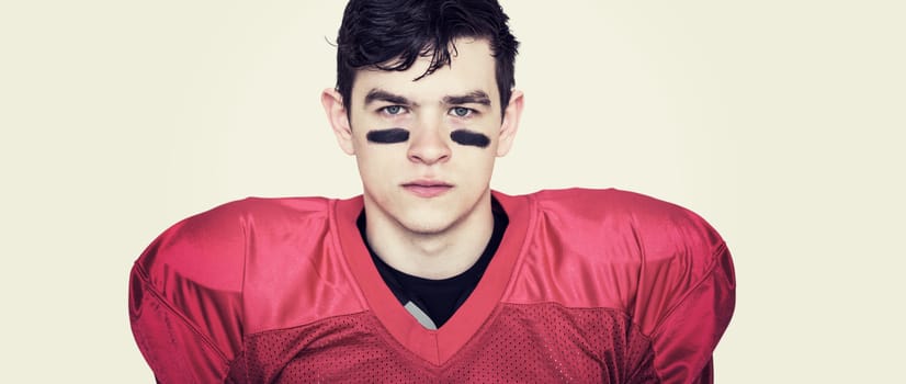 Composite image of serious american football player looking at camera 