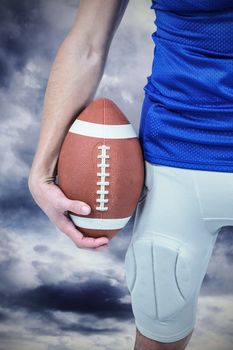 Composite image of sports player holding ball
