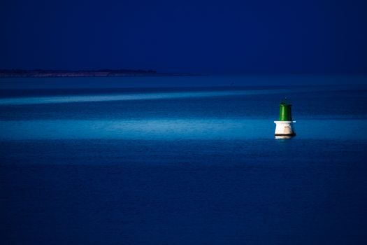 A buoy is reached at night to be repaired.