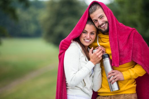 Happy couple under a blanket
