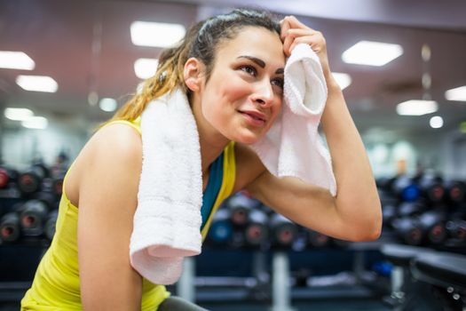 Woman drying her forehead from a workout