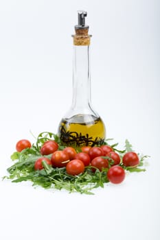 Heap of ruccola, tomatoes and olive oil with the thyme