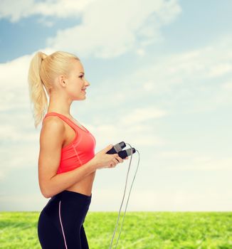 smiling sporty woman with skipping rope