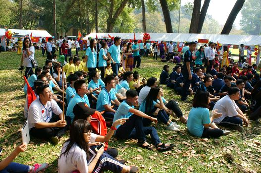 HO CHI MINH CITY, VIET NAM- FEB 9: Group of Asian highschool student in outdoor activity when join spring camp, crowd of teen girl, teen boy sitting and join music, Saigon, Vietnam, Feb 9, 2015