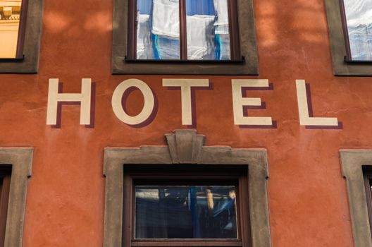 Hotel sign between windows
