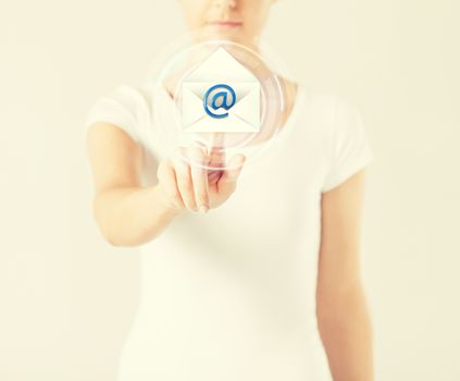woman pressing virtual button with e-mail icon