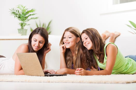 Three cheerful Friends with laptop