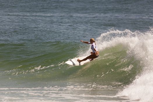 Professional female surfer compete on the Burleigh Pro 2013