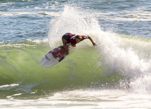 Professional female surfer compete on the Burleigh Pro 2013
