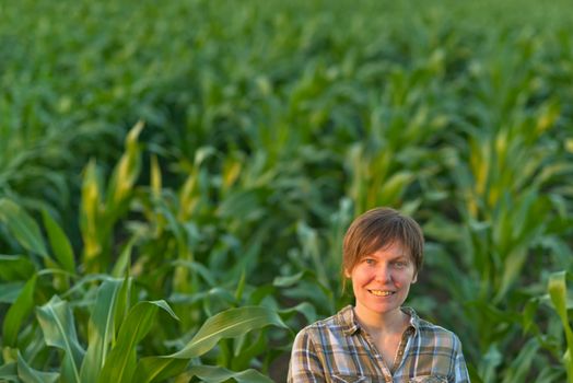 Woman farmer in green corn field