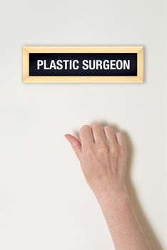 Female hand is knocking on Plastic Surgeon door