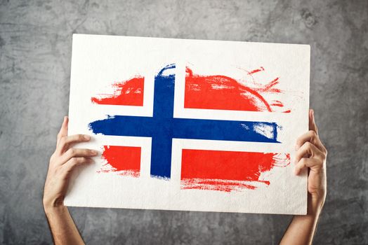 Norway flag. Man holding banner with Norweigan Flag.