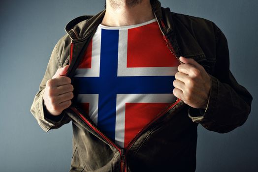 Man stretching jacket to reveal shirt with Norway flag