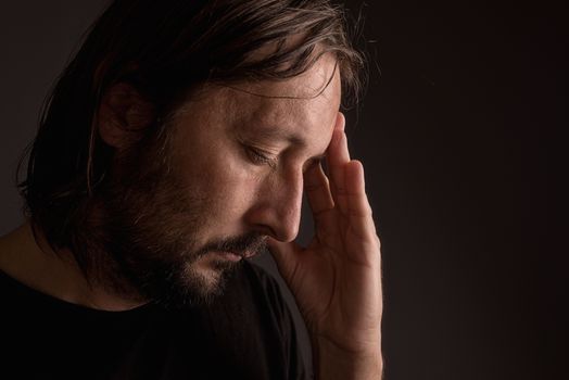 Bearded adult man with migraine headache