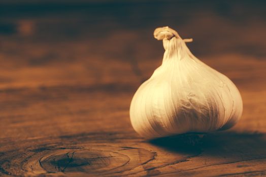 Retro toned whole garlic on table