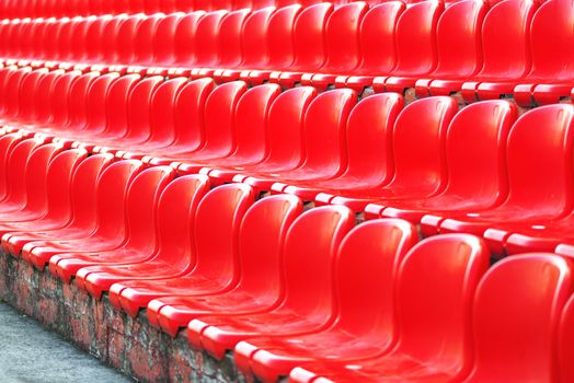 Rows of red empty stadium seats