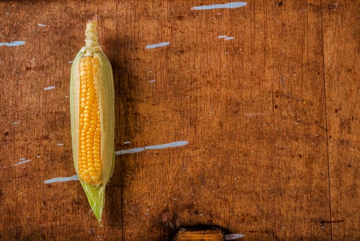 Corn cob on rustic wooden table