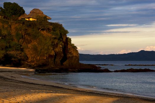 sunrise  stone house cabin hill in a brown beach in nosy be  madagascar