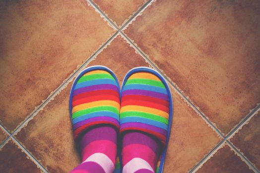 Retro toned rainbow color pattern slippers on the floor
