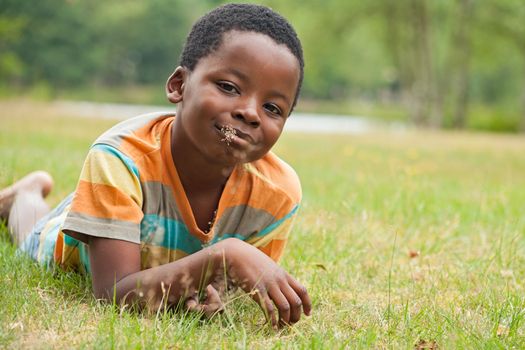 African boy eating grass