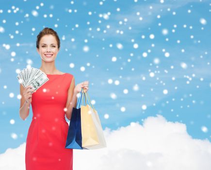 smiling elegant woman in dress with shopping bags