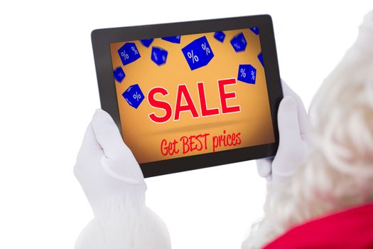 Composite image of santa claus using tablet pc