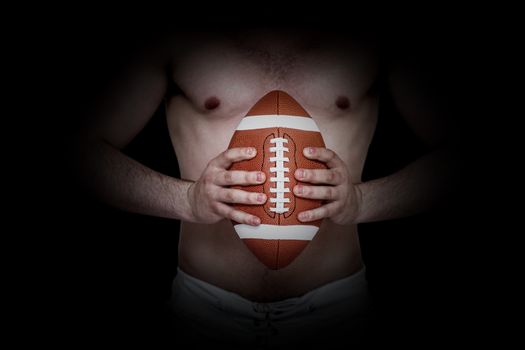 Composite image of shirtless american football player holding a ball