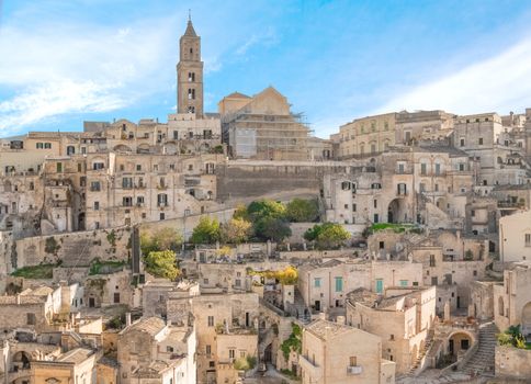panoramic view of typical stones (Sassi di Matera) and church of Matera UNESCO European Capital of Culture 2019 under blue sky. Basilicata, Italy