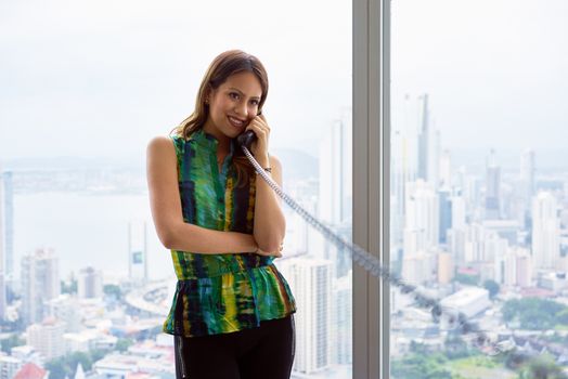 2 Young Latina Businesswoman With Wired Telephone In Modern Offi