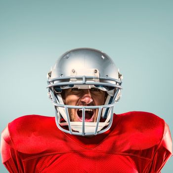 Composite image of aggressive american football player in red jersey screaming