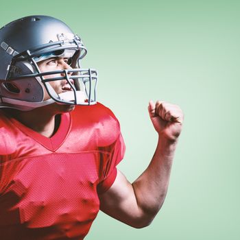 Composite image of american football player cheering with clenched fist
