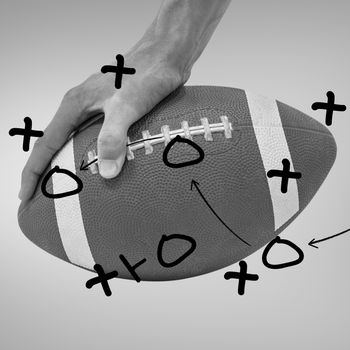 Composite image of close-up of american football player placing the ball