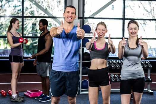 Women and trainer with thumbs up