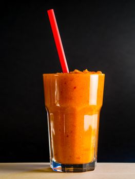 Carrot smoothie with black background