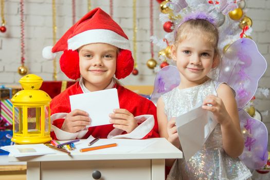 Makeshift Santa Claus and fairy prepare congratulatory letters