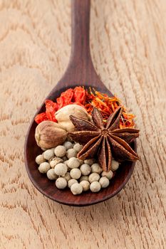 Spices in wooden spoon saffron, matrimony vine(chinese wolfberry